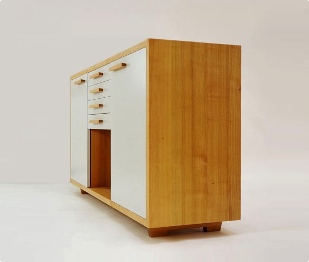 Custom wooden cabinet with white drawers and doors on a light background